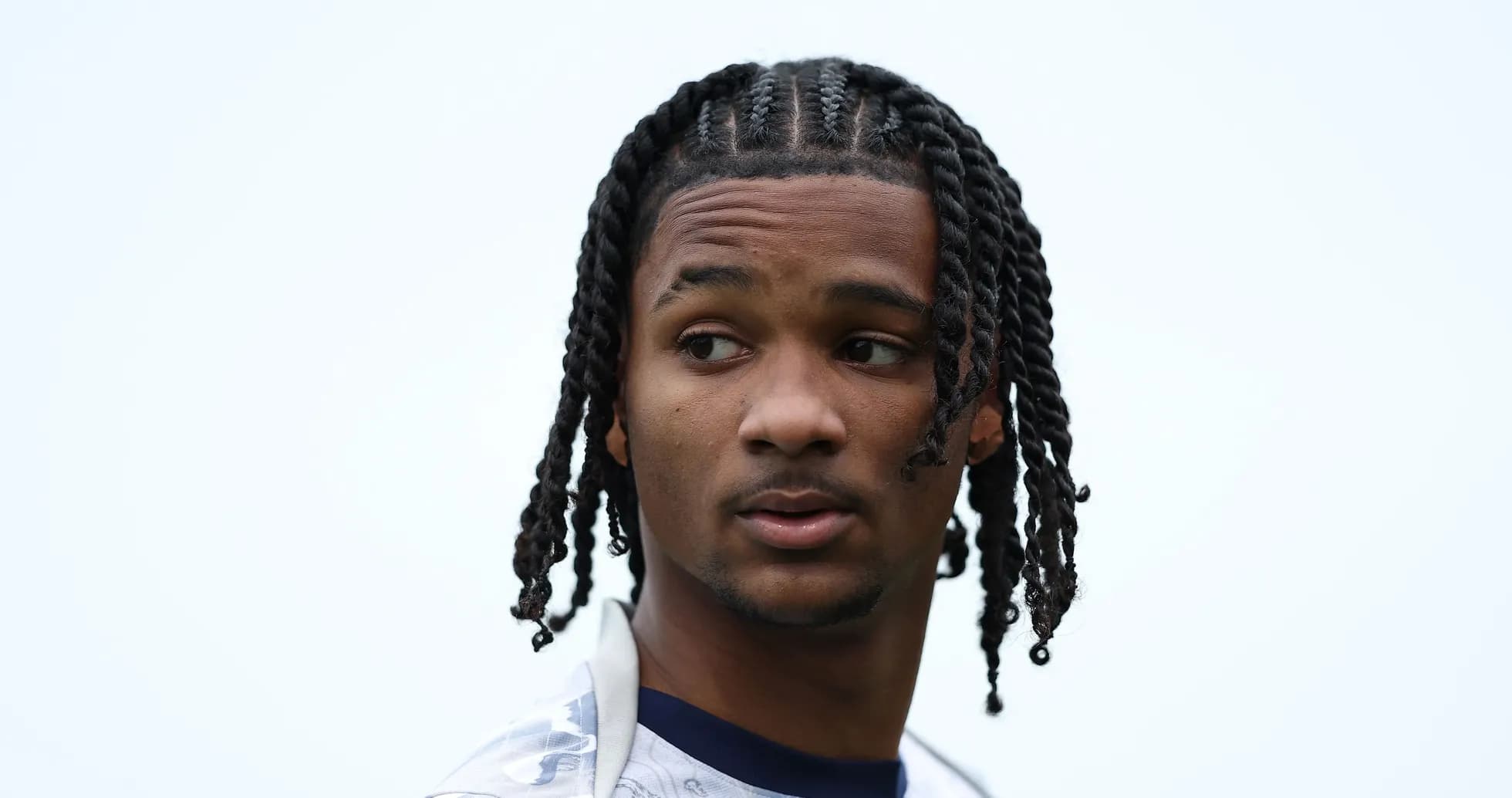 Player with braided hair looking away outdoors Player with braided hair looking away outdoors