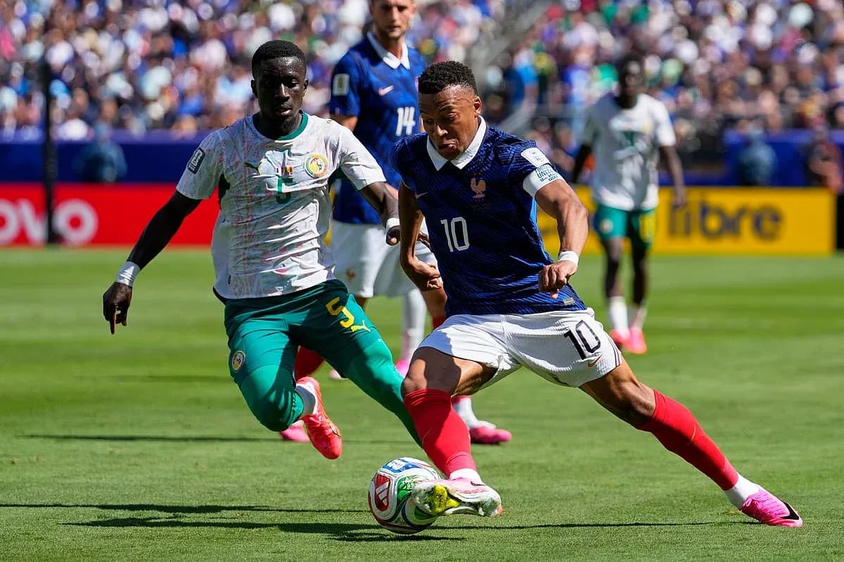 France player dribbling past Senegal defender France player dribbling past Senegal defender