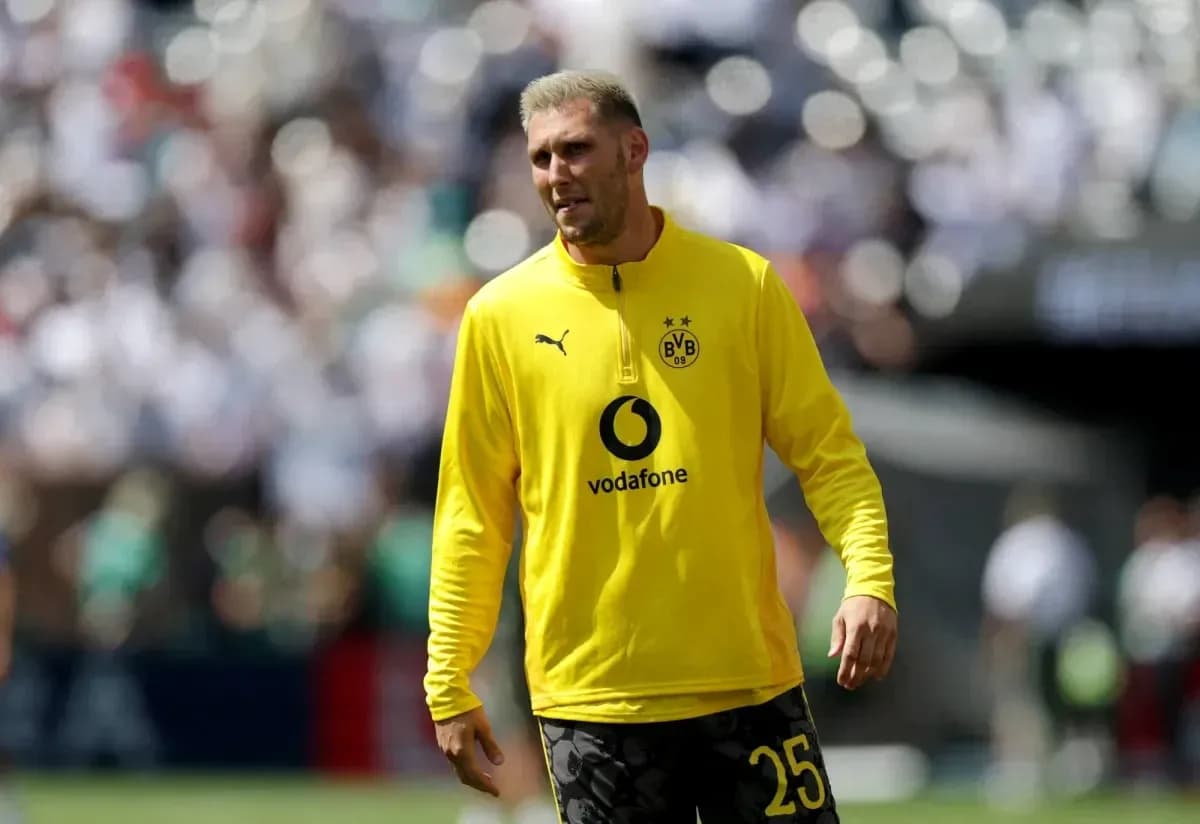 Player in yellow Borussia Dortmund training kit on field Player in yellow Borussia Dortmund training kit on field