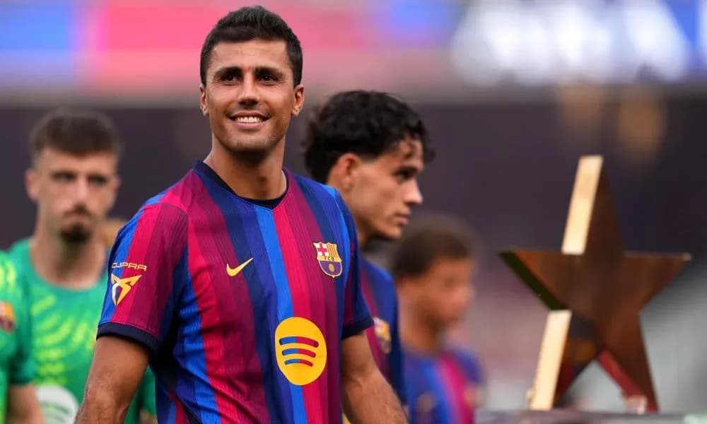 Player smiling while holding trophy during ceremony Player smiling while holding trophy during ceremony
