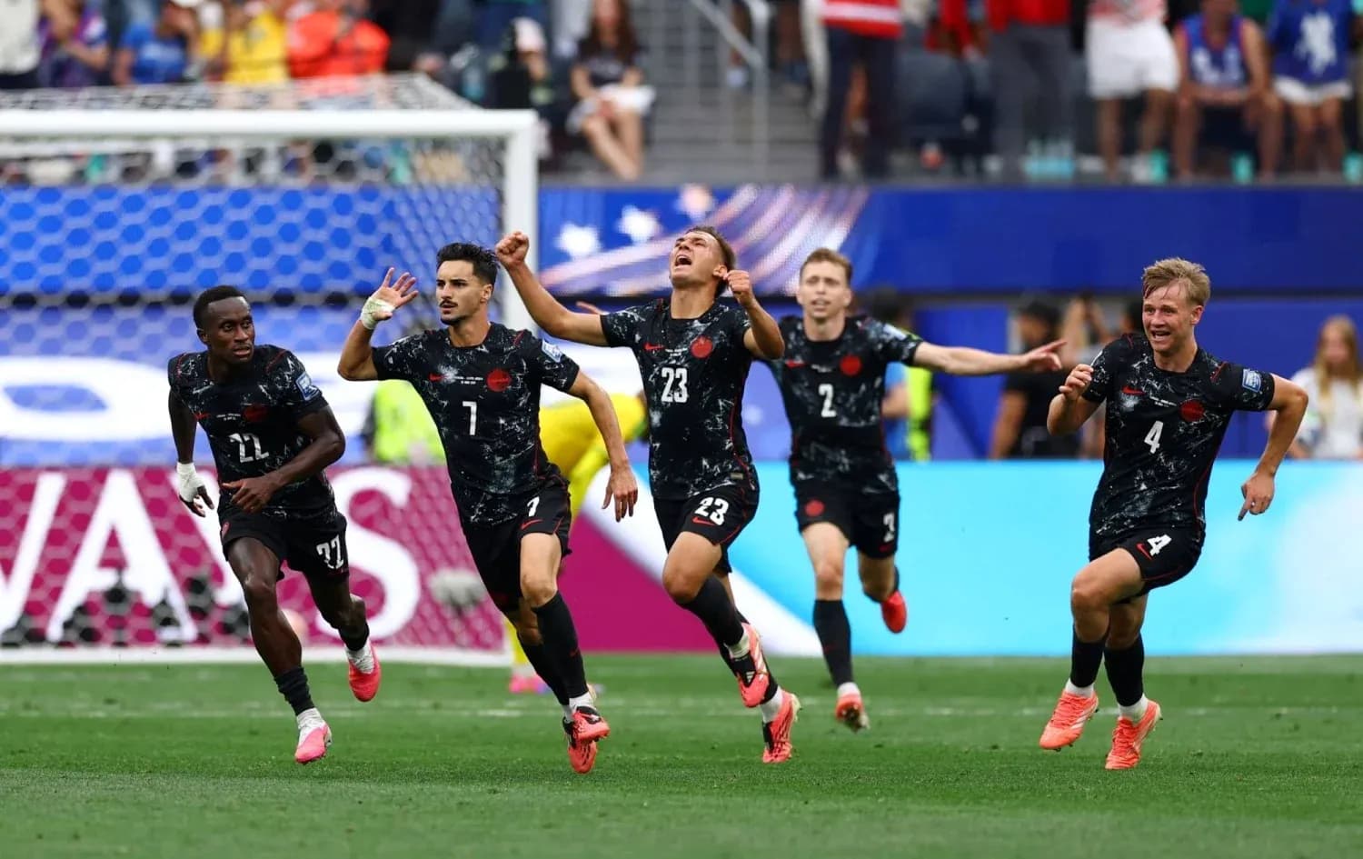 Players celebrating a goal during a match Players celebrating a goal during a match