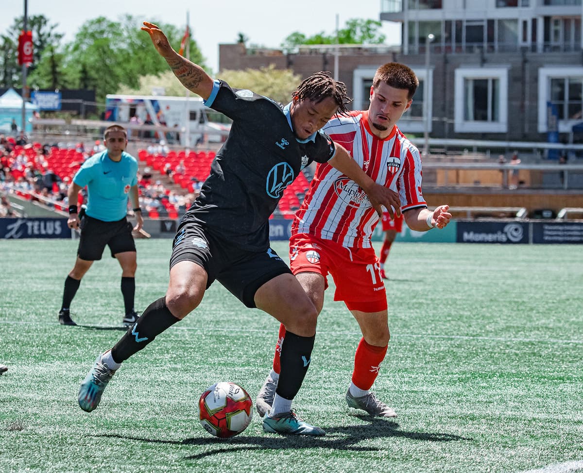 Player challenging for the ball during match Player challenging for the ball during match