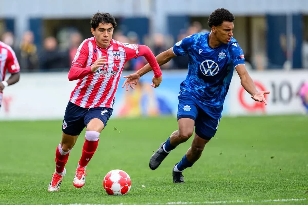 HFX Wanderers FC player dribbling past Atlético Ottawa opponent HFX Wanderers FC player dribbling past Atlético Ottawa opponent