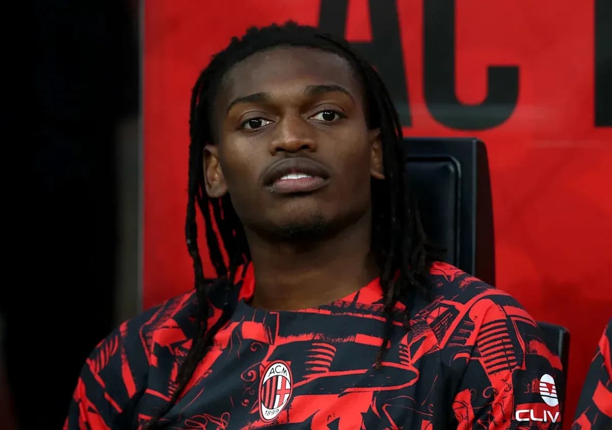 Player sitting on the bench in AC Milan kit Player sitting on the bench in AC Milan kit