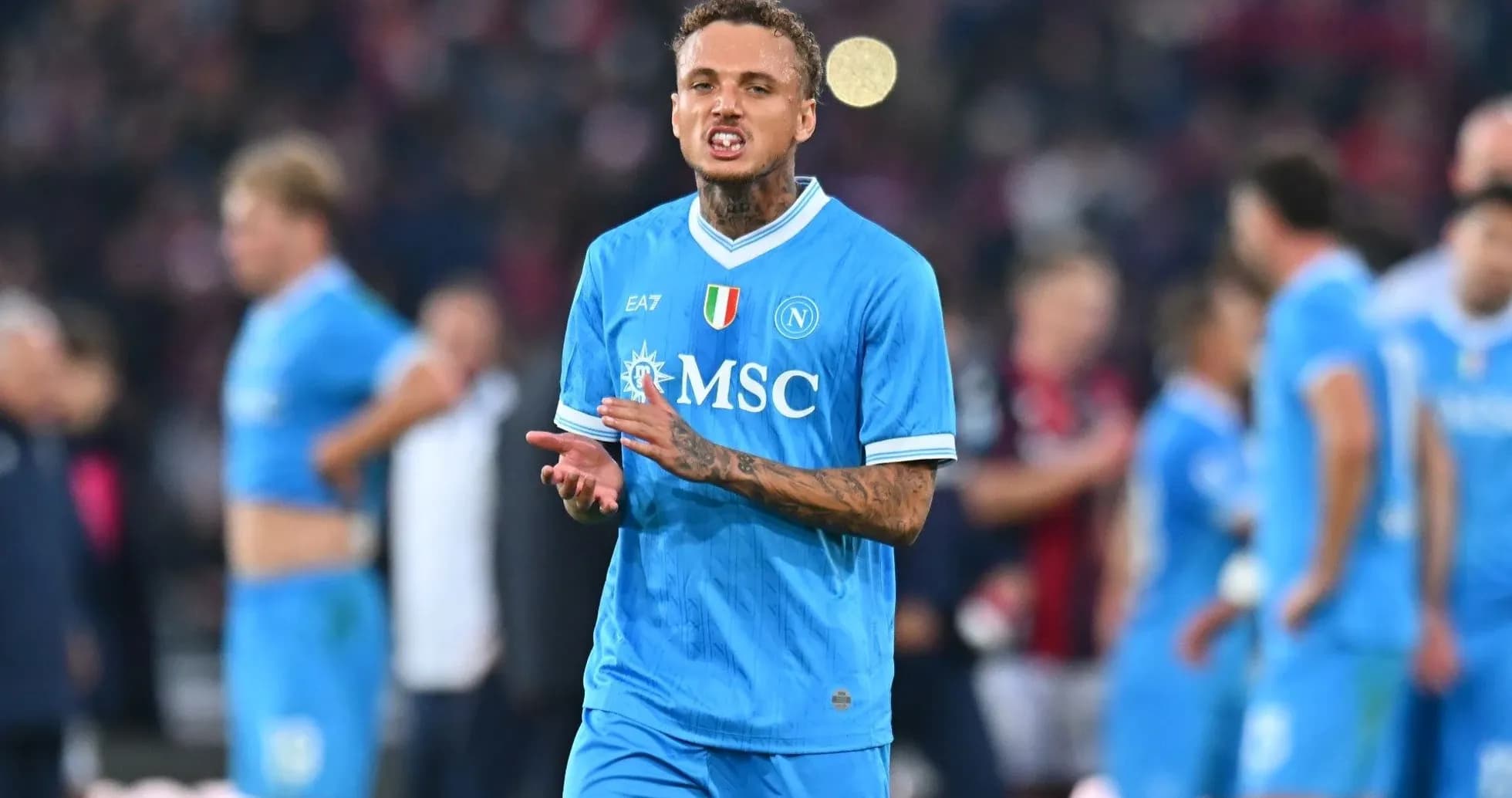 Player gesturing during match with teammates in background Player gesturing during match with teammates in background