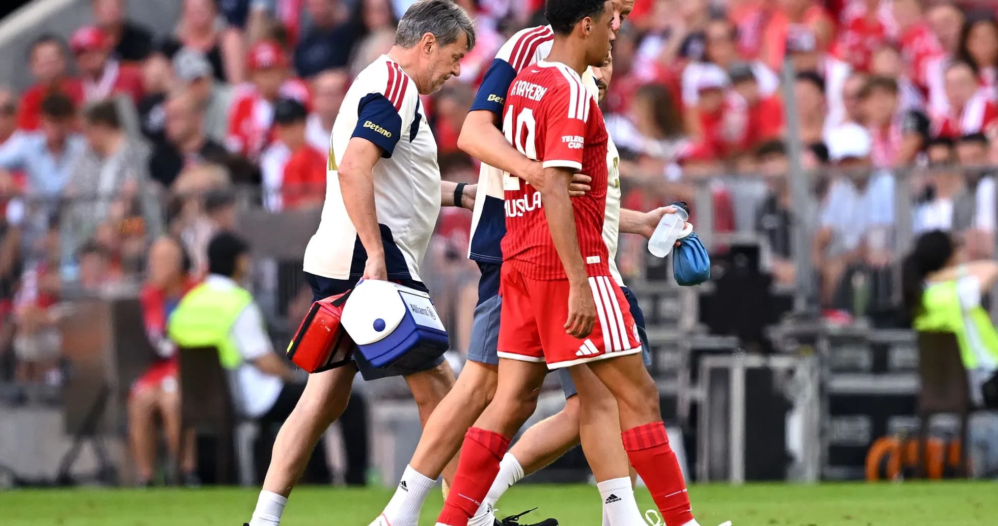 Player being assisted off the field by staff Player being assisted off the field by staff