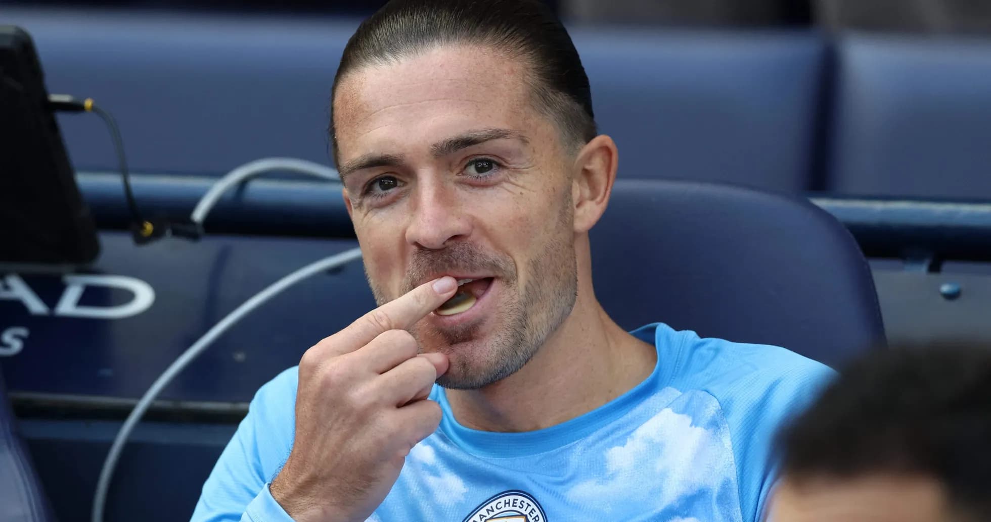 Player eating while seated on the bench Player eating while seated on the bench