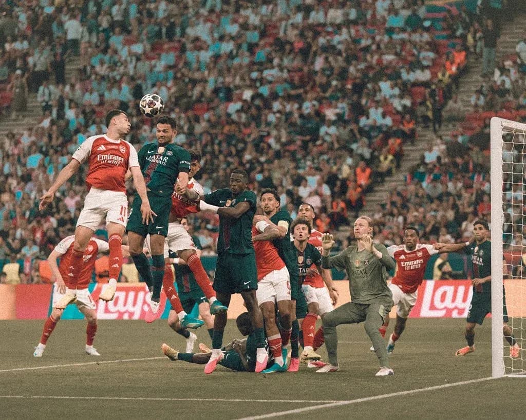 Players contesting for a header during a corner kick Players contesting for a header during a corner kick