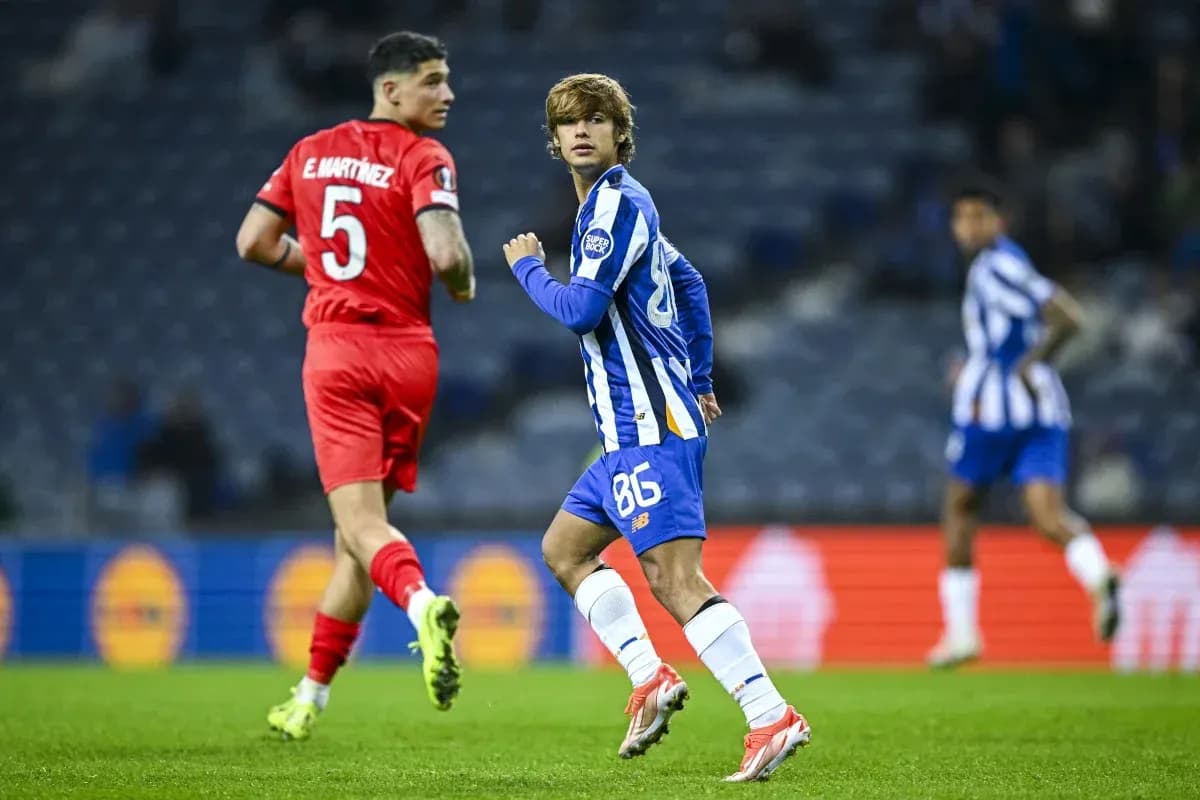 Player in blue jersey running on the pitch Player in blue jersey running on the pitch