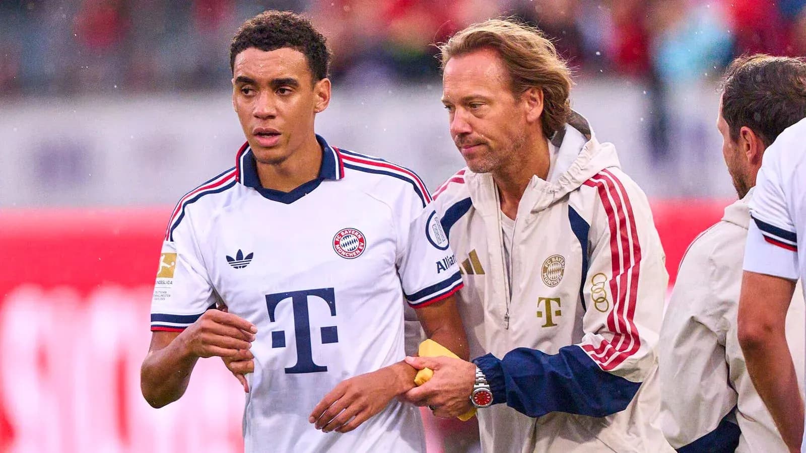Bayern Munich player receiving guidance from coach Bayern Munich player receiving guidance from coach