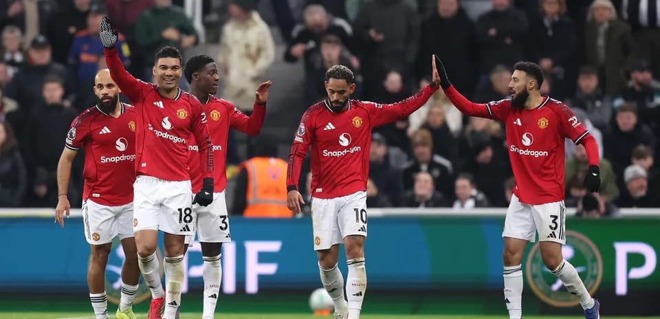 Manchester United players celebrating a goal on field Manchester United players celebrating a goal on field