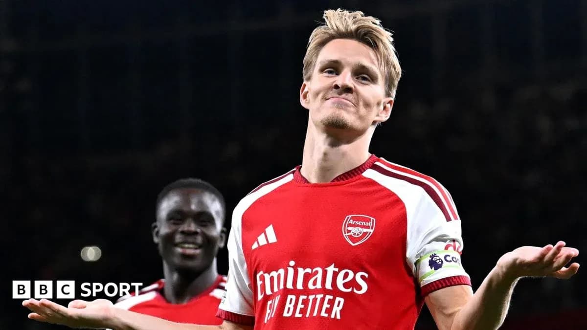 Arsenal player celebrating with teammate after scoring Arsenal player celebrating with teammate after scoring