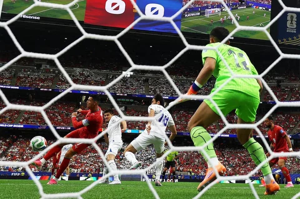 Goalkeeper diving as players contest the ball Goalkeeper diving as players contest the ball