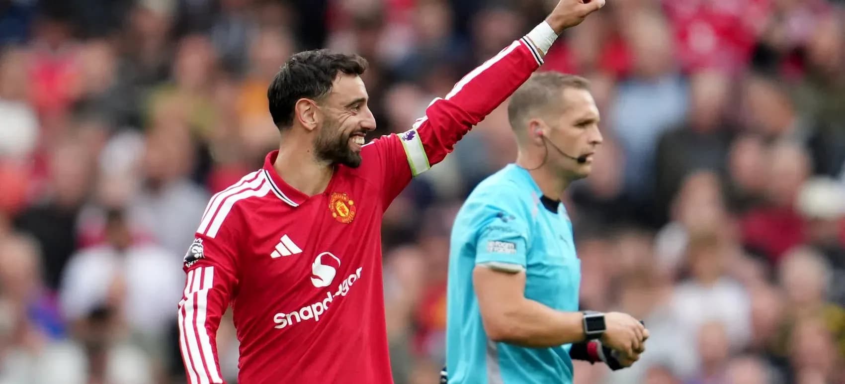 Bruno Fernandes celebrating during a match with referee Bruno Fernandes celebrating during a match with referee