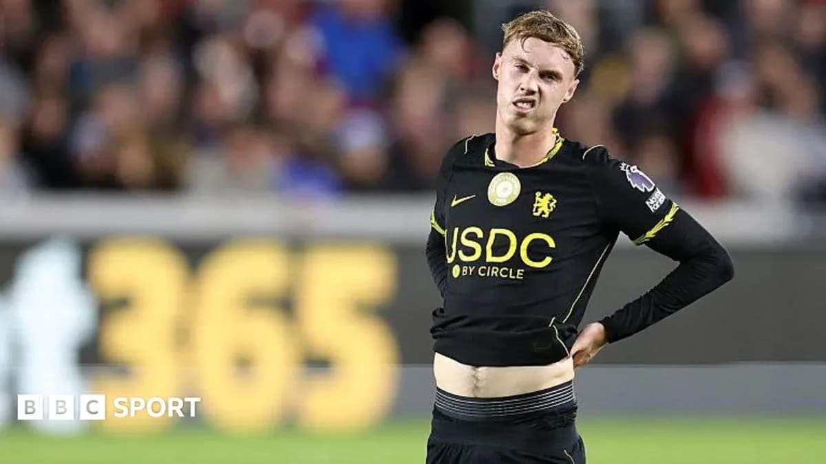 Player in black kit showing signs of discomfort Player in black kit showing signs of discomfort