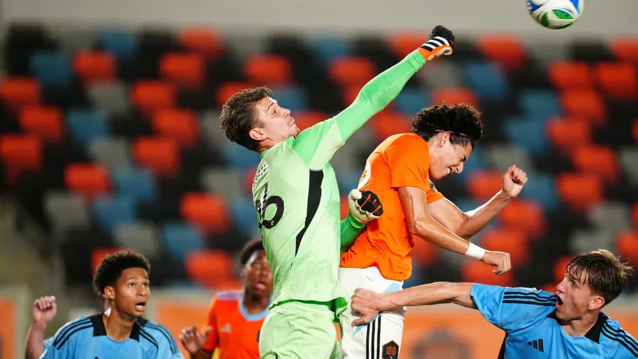 Goalkeeper punching the ball during match action Goalkeeper punching the ball during match action