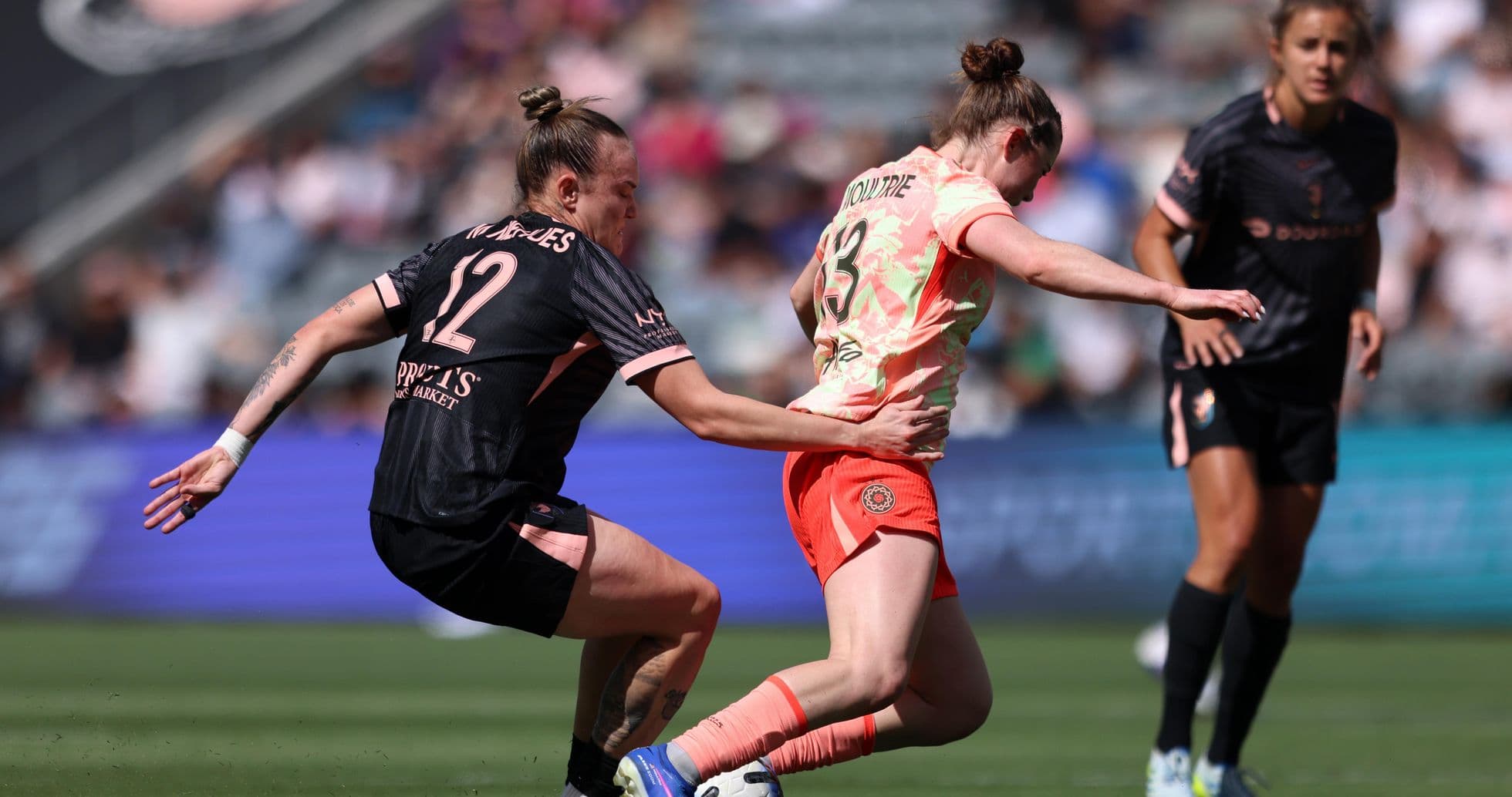 Players competing for the ball during NWSL match Players competing for the ball during NWSL match