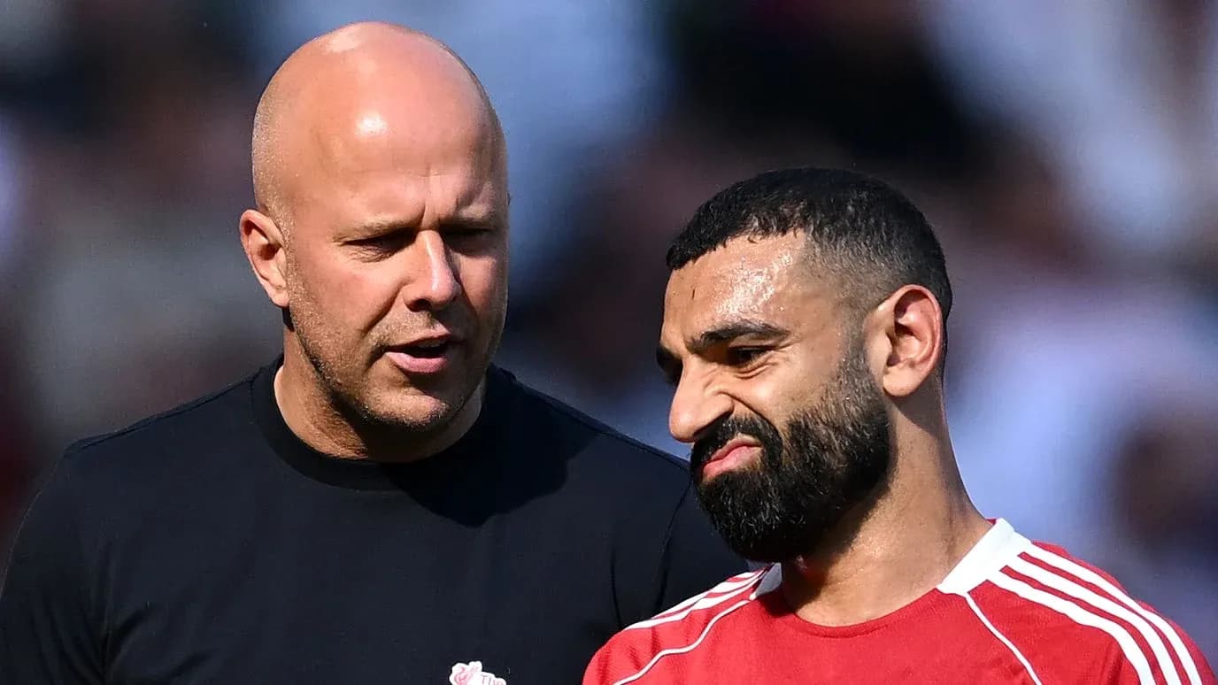 Two men discussing on the pitch after match Two men discussing on the pitch after match