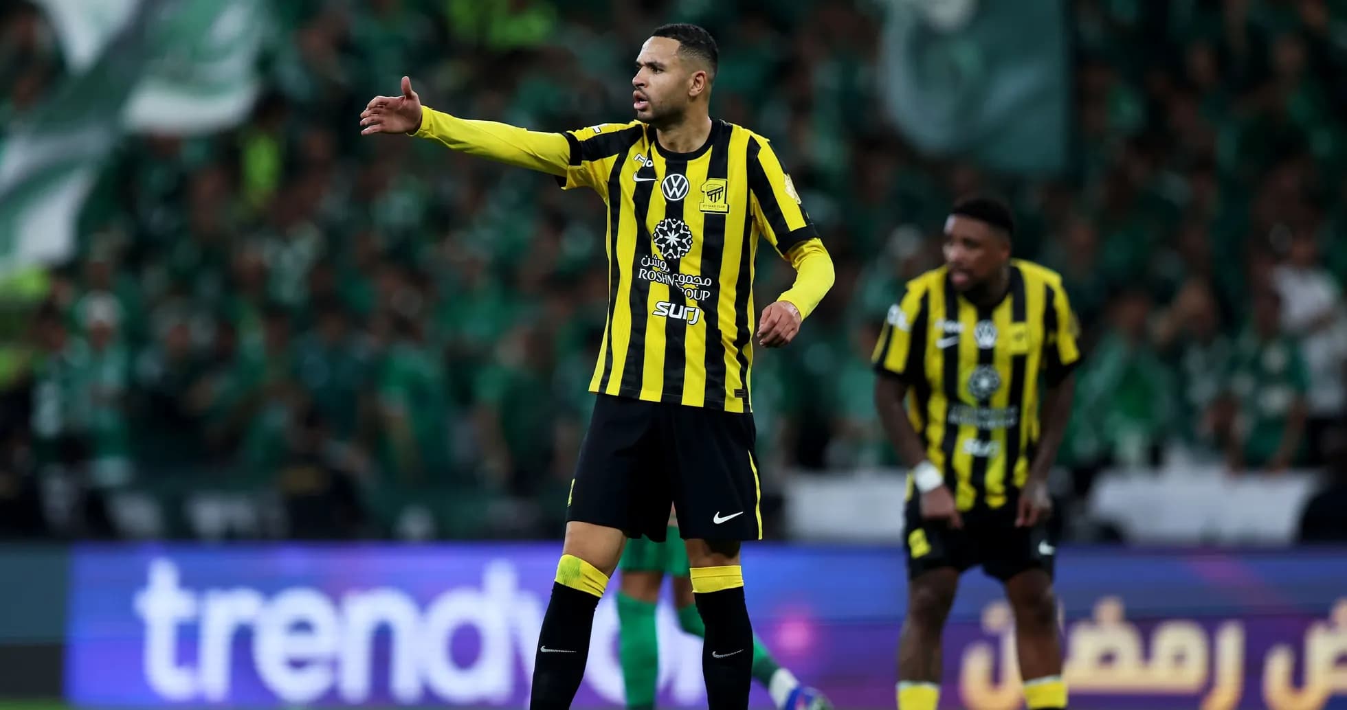 Player gesturing during match with green crowd behind Player gesturing during match with green crowd behind