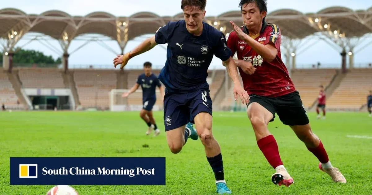 Player in blue jersey dribbling past opponent in red jersey Player in blue jersey dribbling past opponent in red jersey