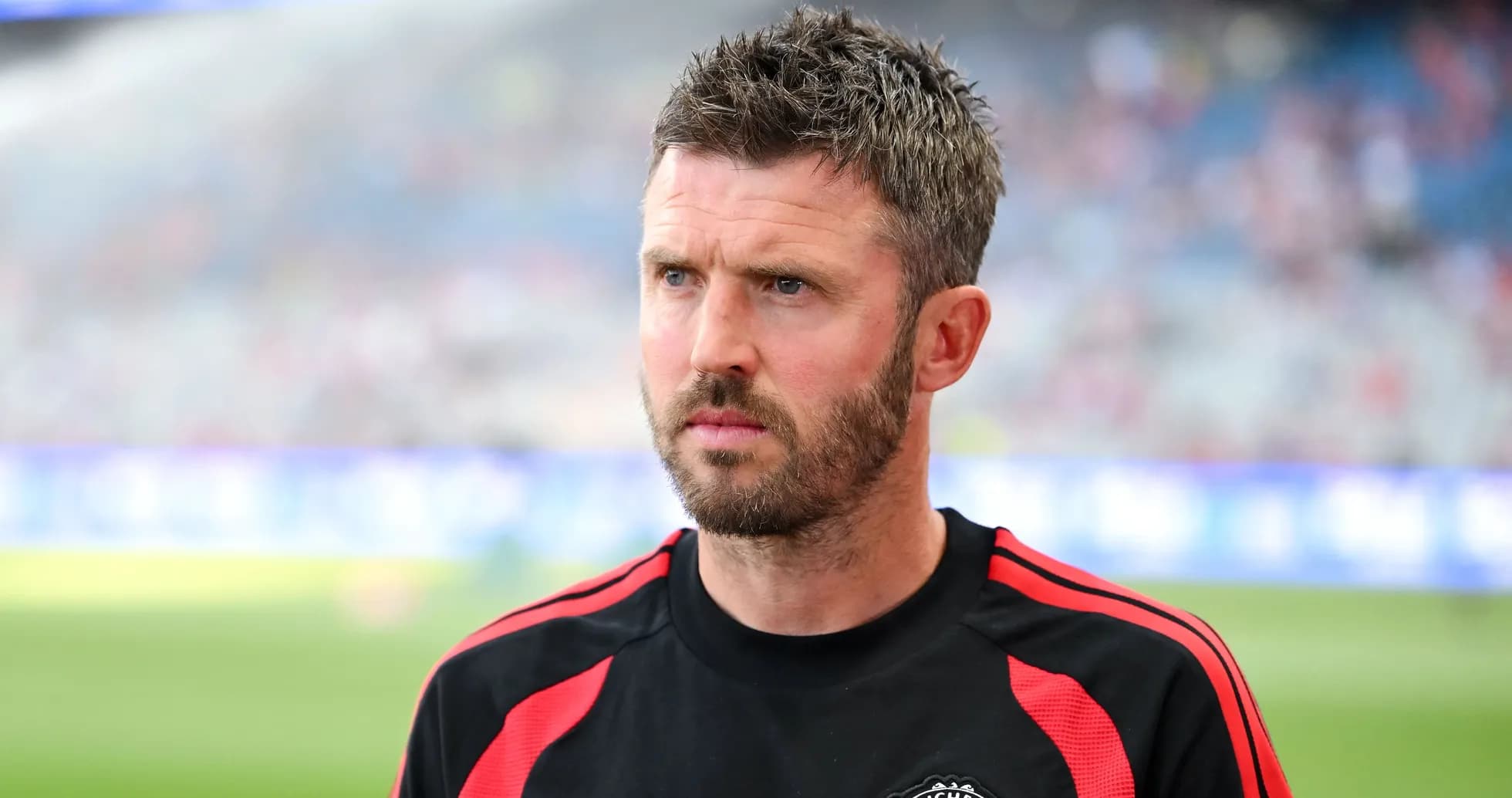 Coach wearing Manchester United training kit on pitch Coach wearing Manchester United training kit on pitch