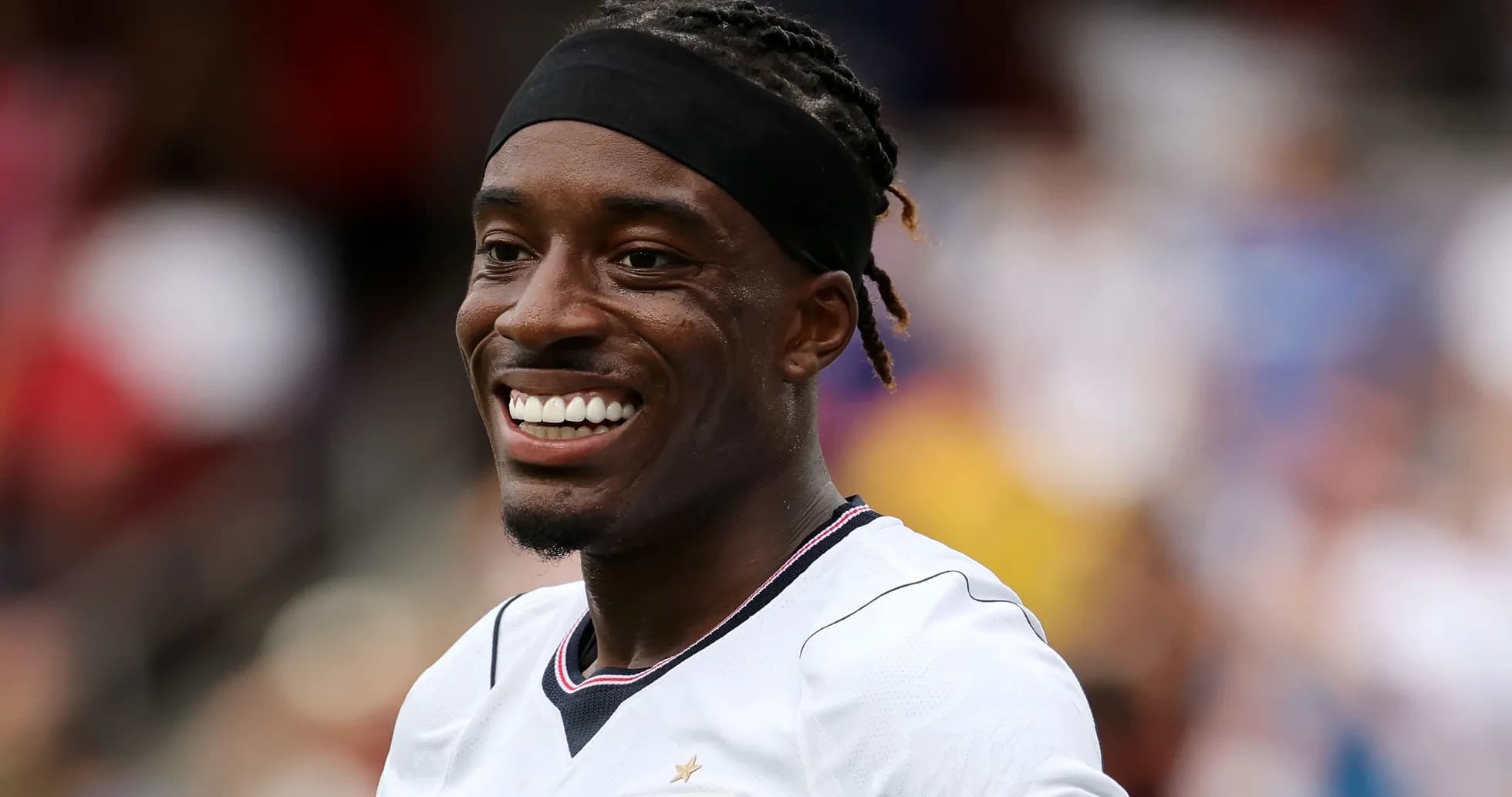 Player smiling during a soccer match Player smiling during a soccer match