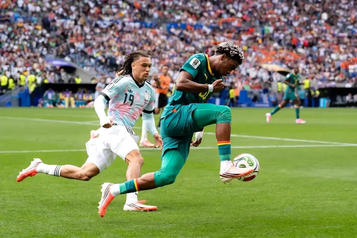 Player dribbling the ball while being pursued by opponent Player dribbling the ball while being pursued by opponent