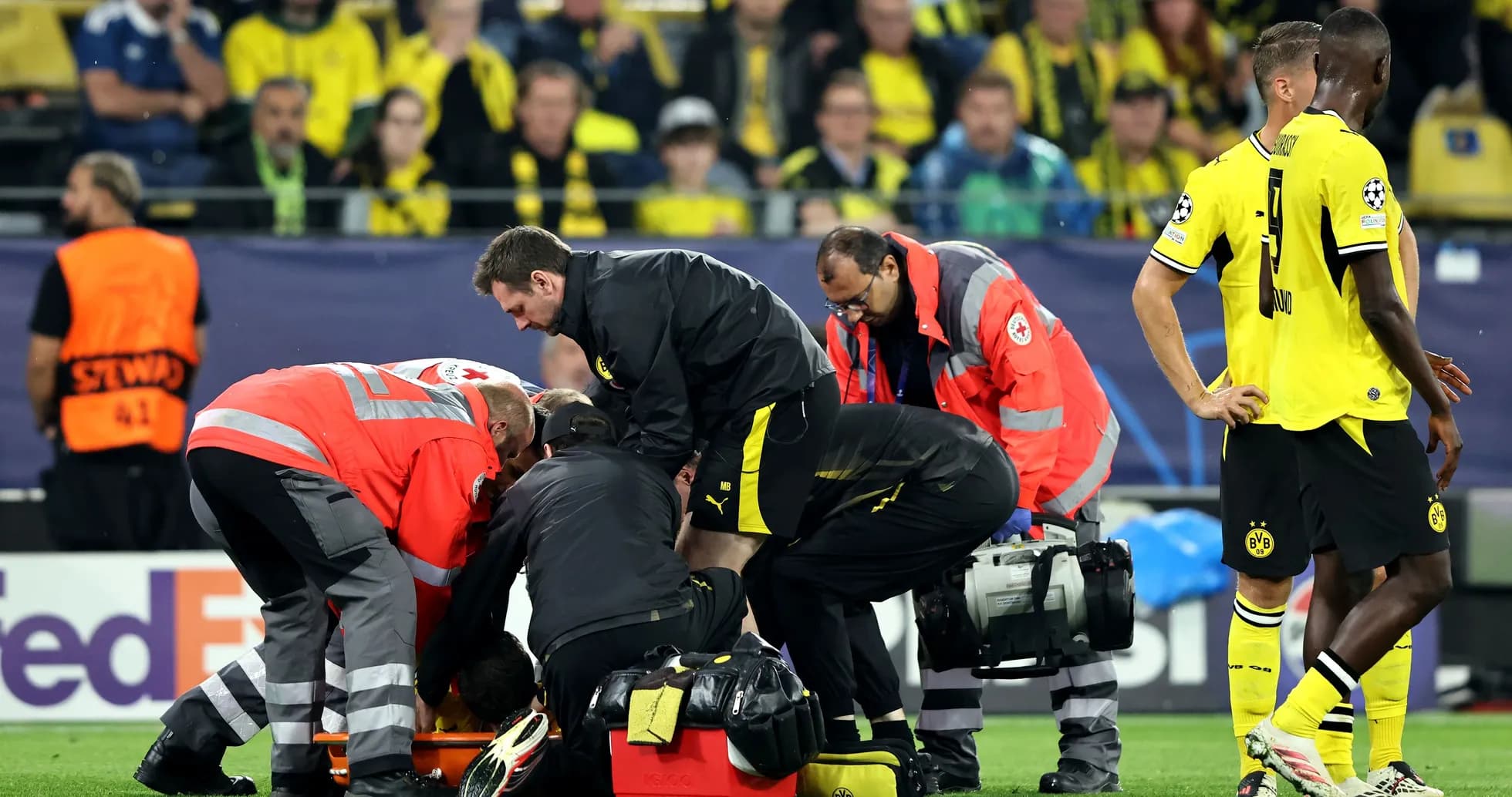 Medical staff attending to an injured player on field Medical staff attending to an injured player on field