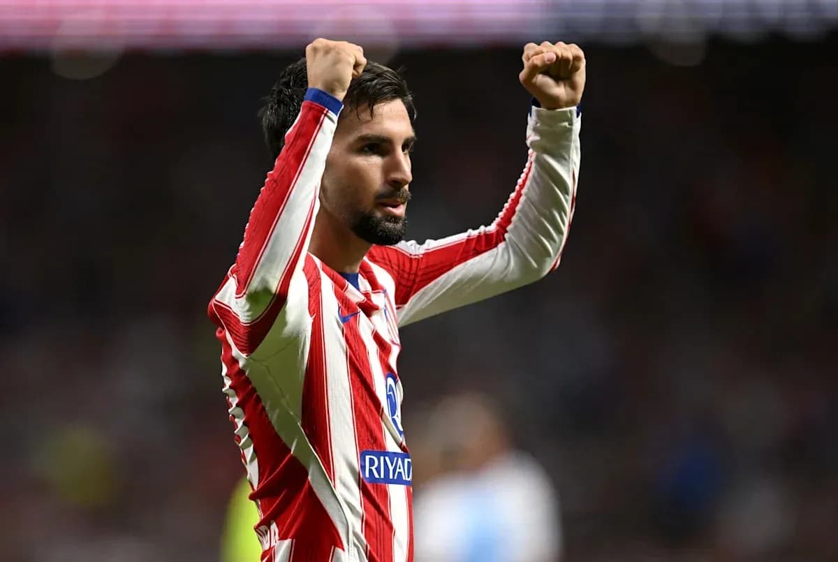 Player celebrating with raised fists on the field Player celebrating with raised fists on the field