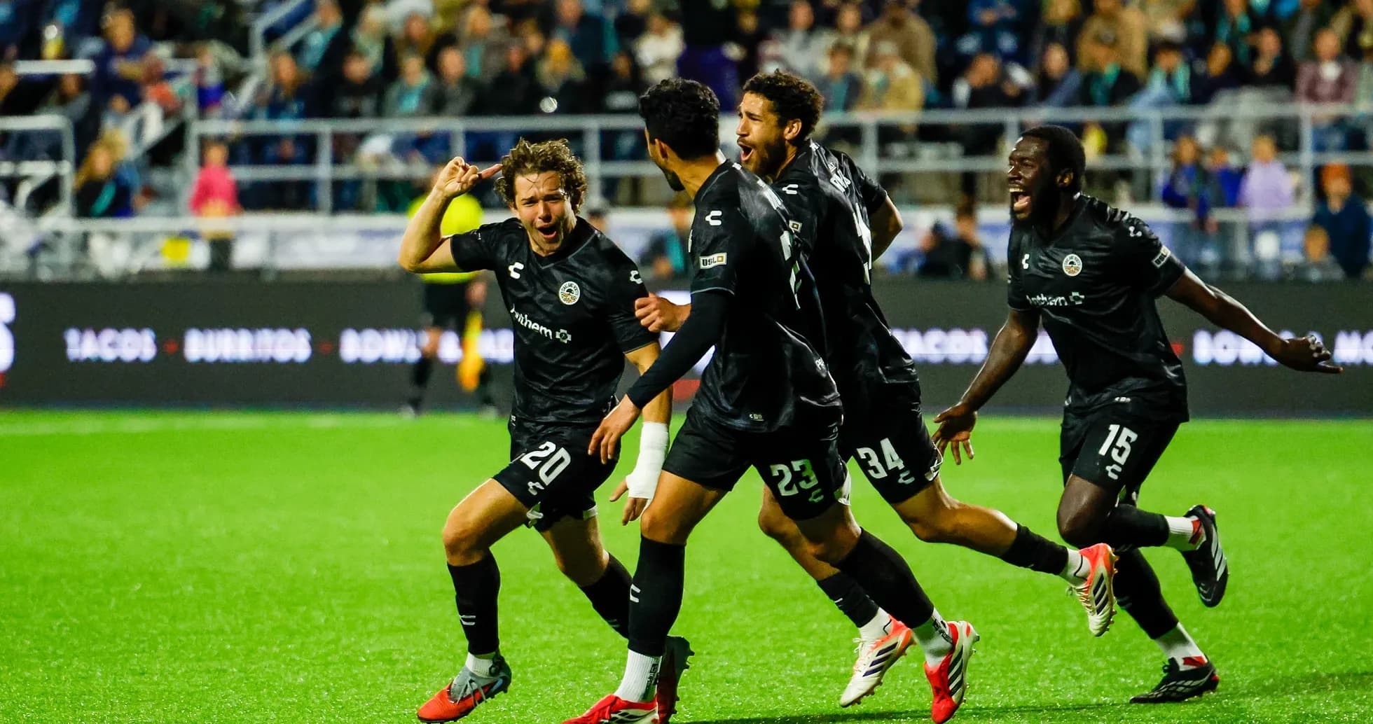 Players celebrating a goal during match Players celebrating a goal during match