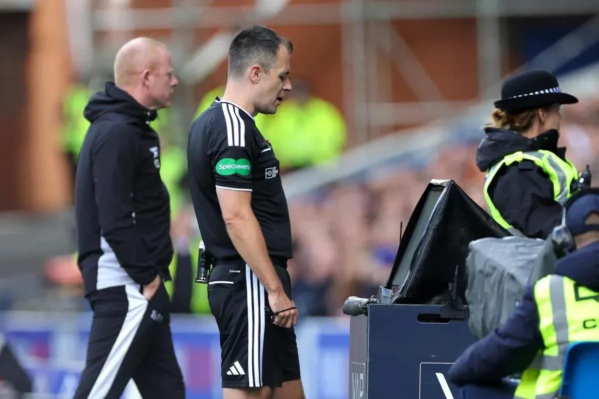 Referee consulting VAR monitor during match decision Referee consulting VAR monitor during match decision