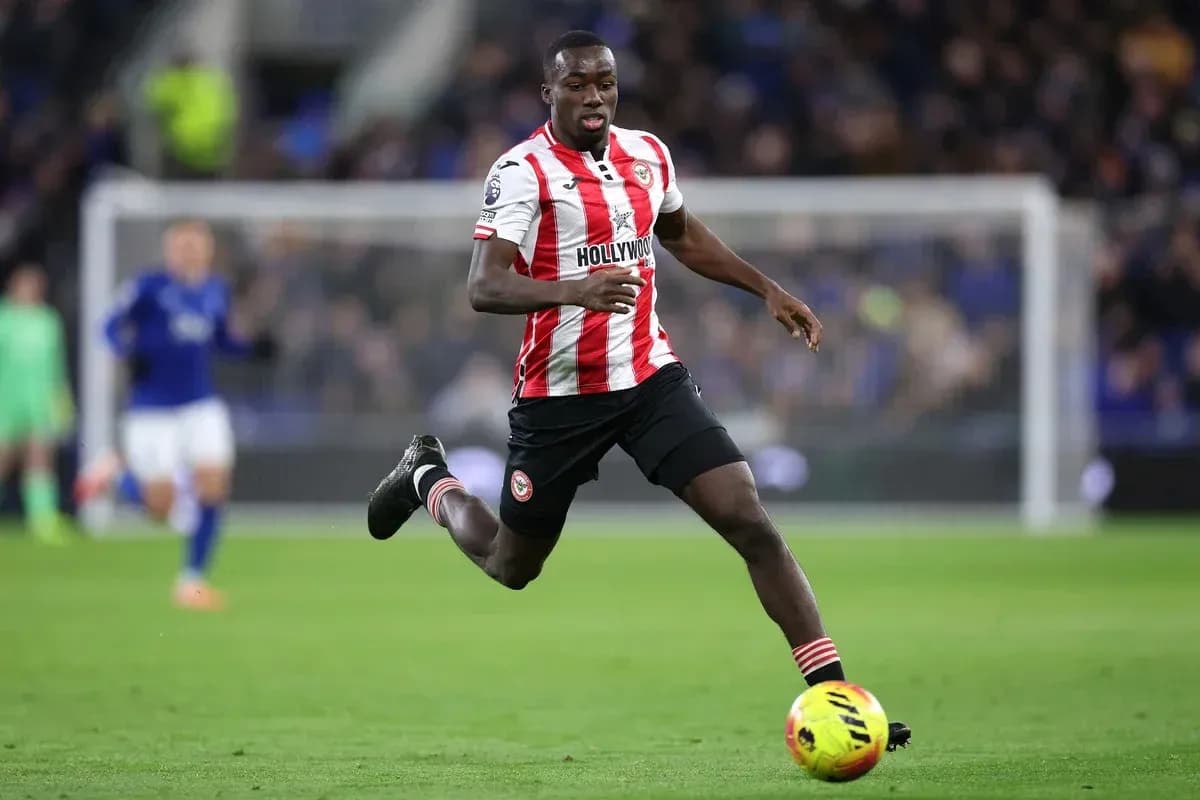 Player in red and white kit running on the pitch Player in red and white kit running on the pitch
