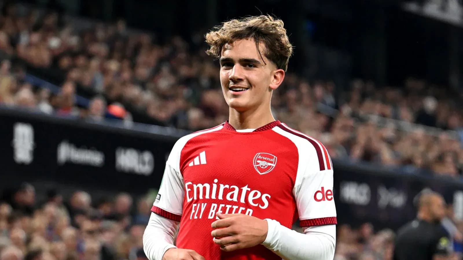 Arsenal player smiling during match at stadium Arsenal player smiling during match at stadium