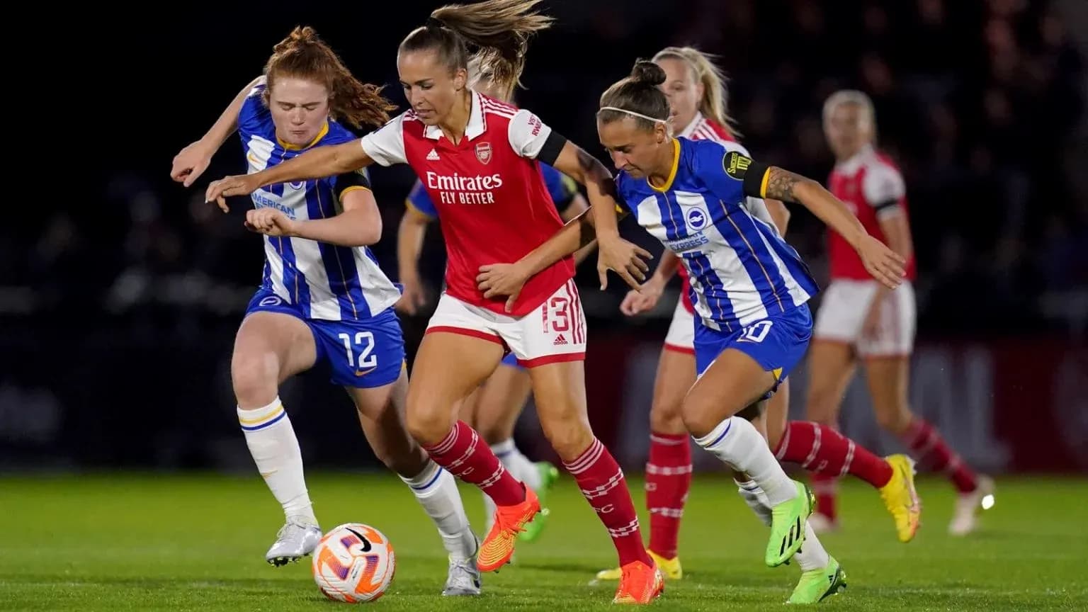 Brighton W and Arsenal W players competing for the ball Brighton W and Arsenal W players competing for the ball