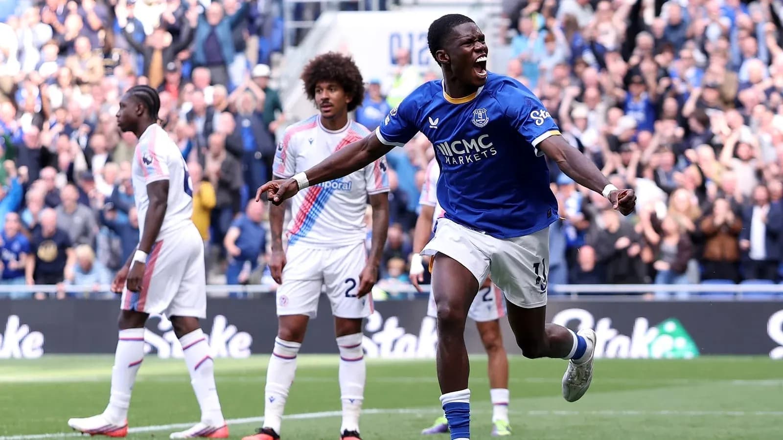 Player celebrating goal with fans in background Player celebrating goal with fans in background