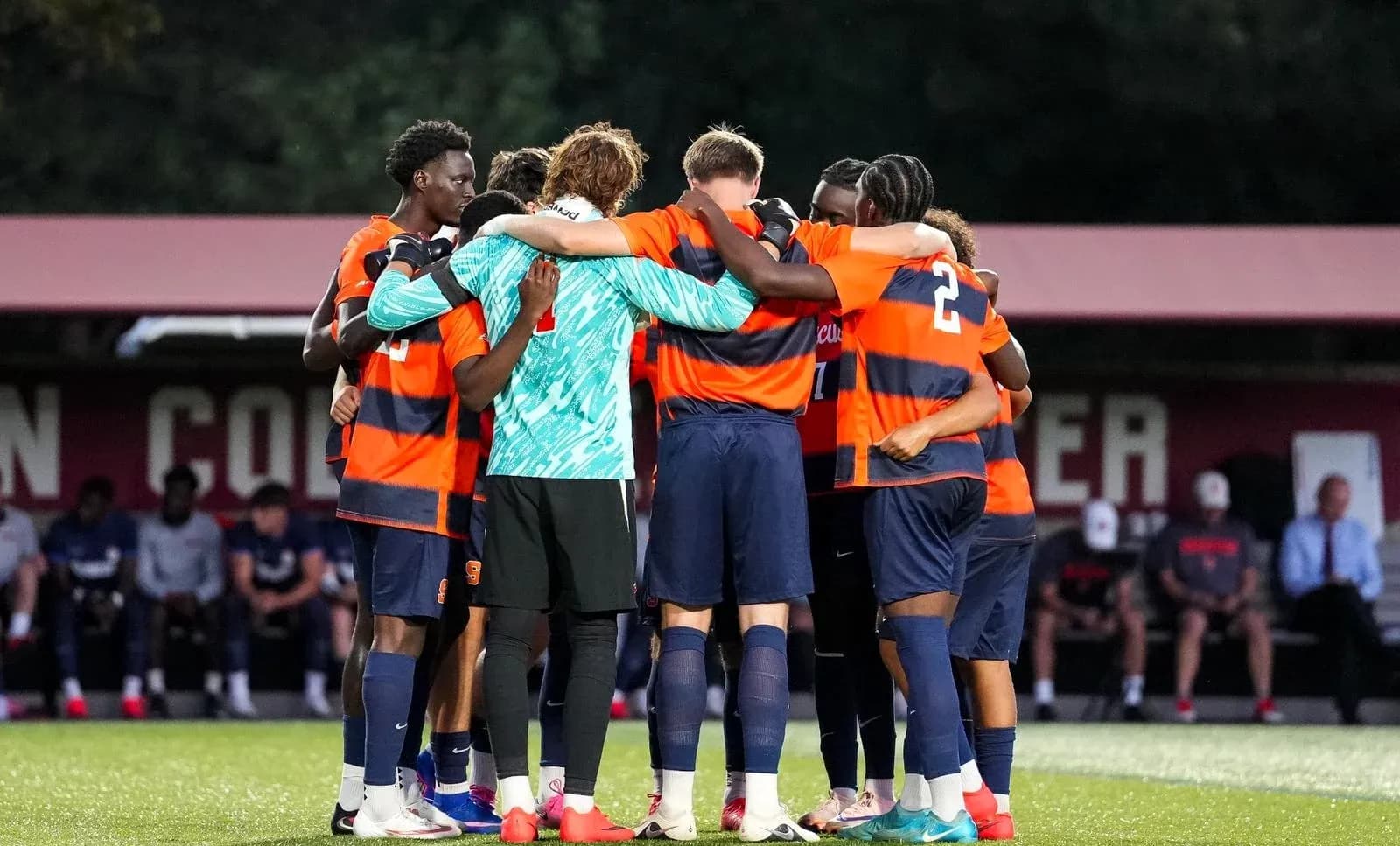 Soccer team huddled together before match Soccer team huddled together before match