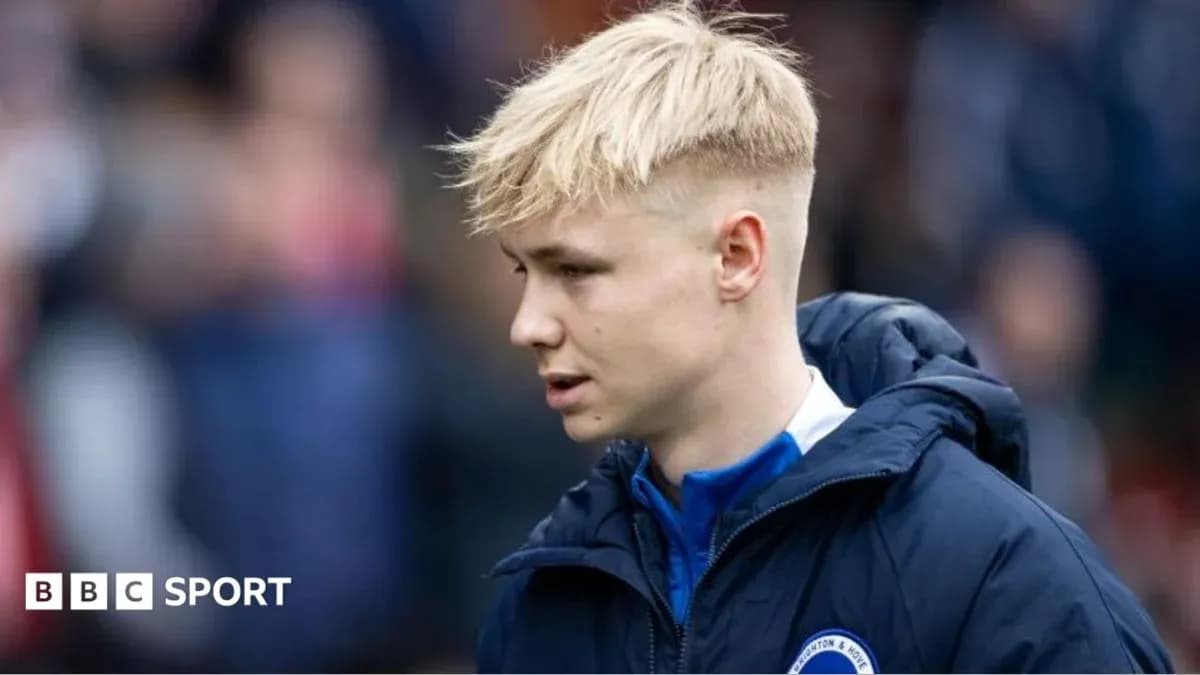 Player walking on the pitch in team jacket Player walking on the pitch in team jacket