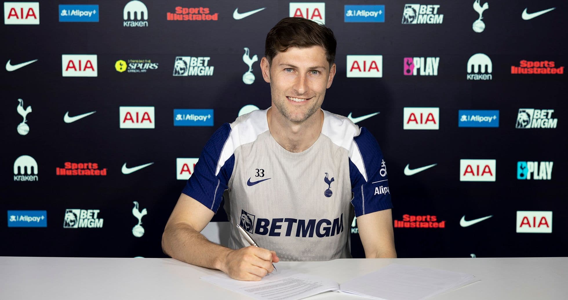 Player signing contract at Tottenham press conference Player signing contract at Tottenham press conference