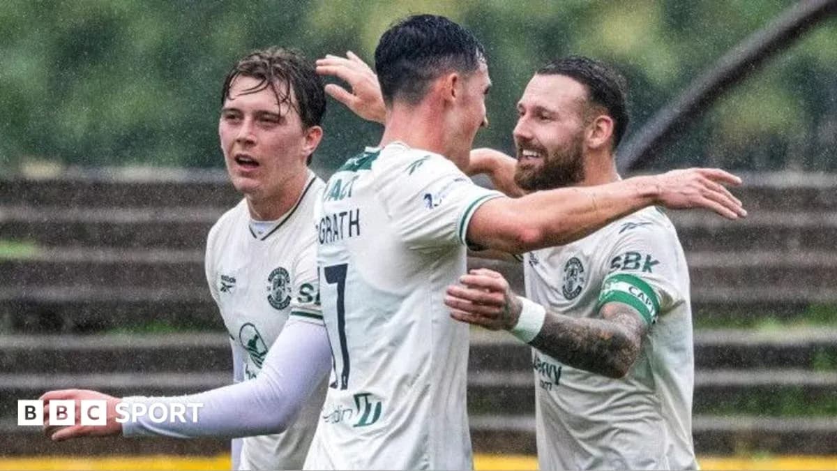Hibernian players celebrating a goal in the rain Hibernian players celebrating a goal in the rain