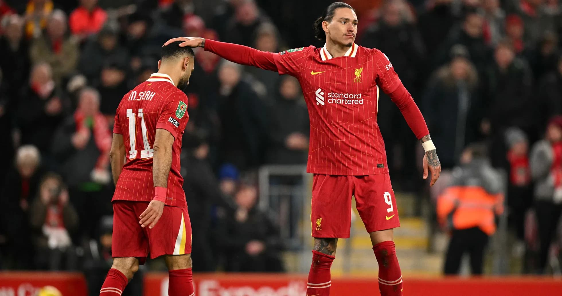 Liverpool players interacting on the pitch during match Liverpool players interacting on the pitch during match