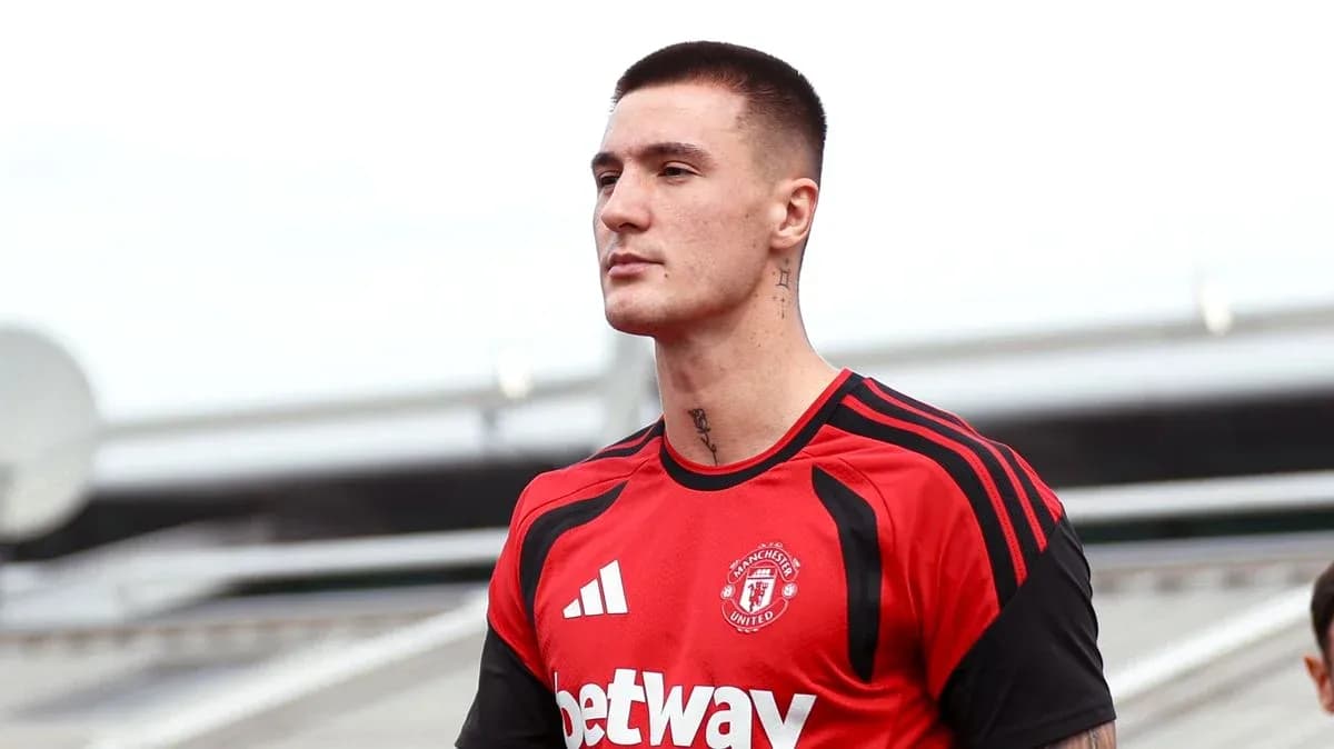 Player in Manchester United training kit on pitch Player in Manchester United training kit on pitch