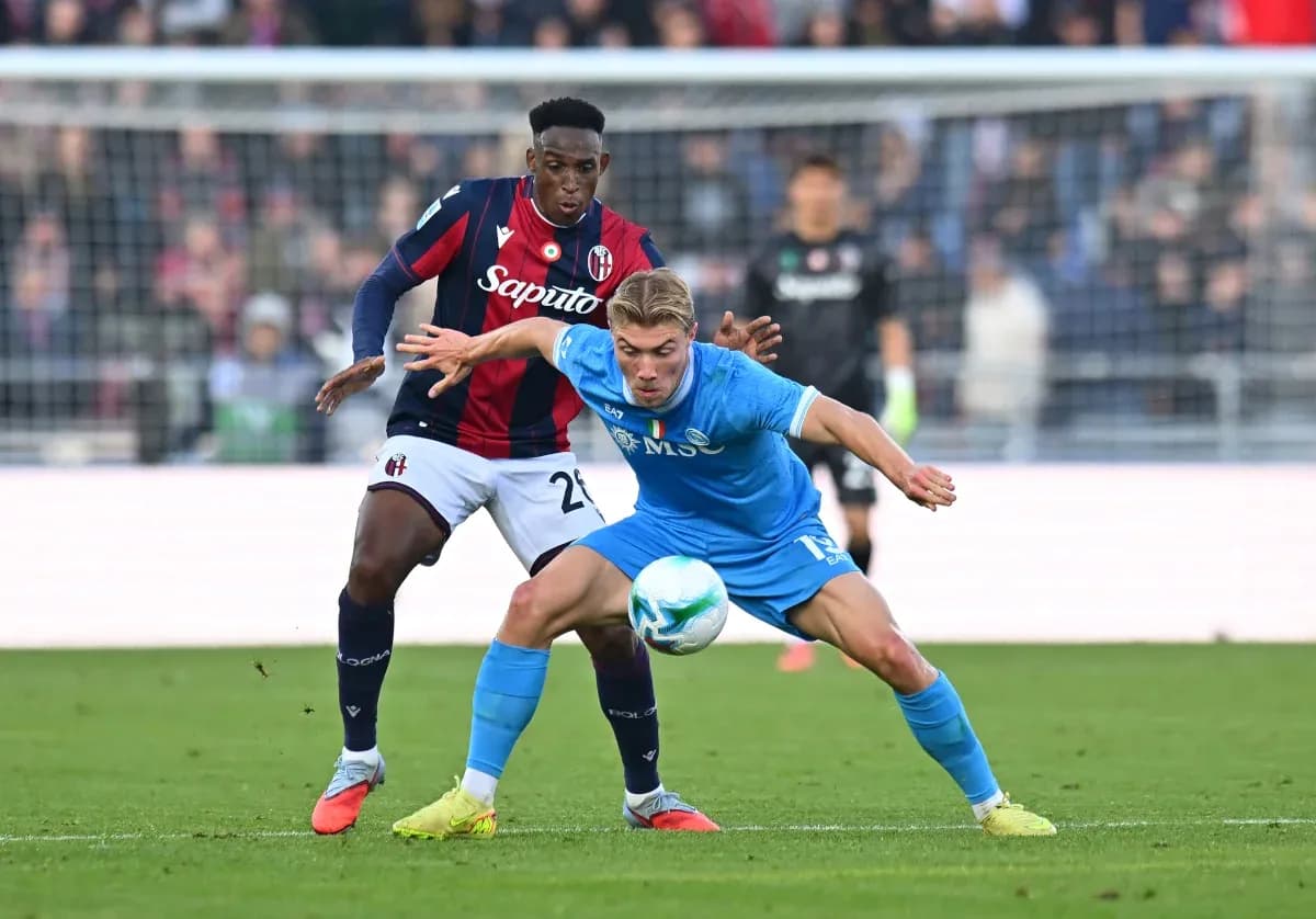 Napoli player challenging Bologna defender for ball Napoli player challenging Bologna defender for ball