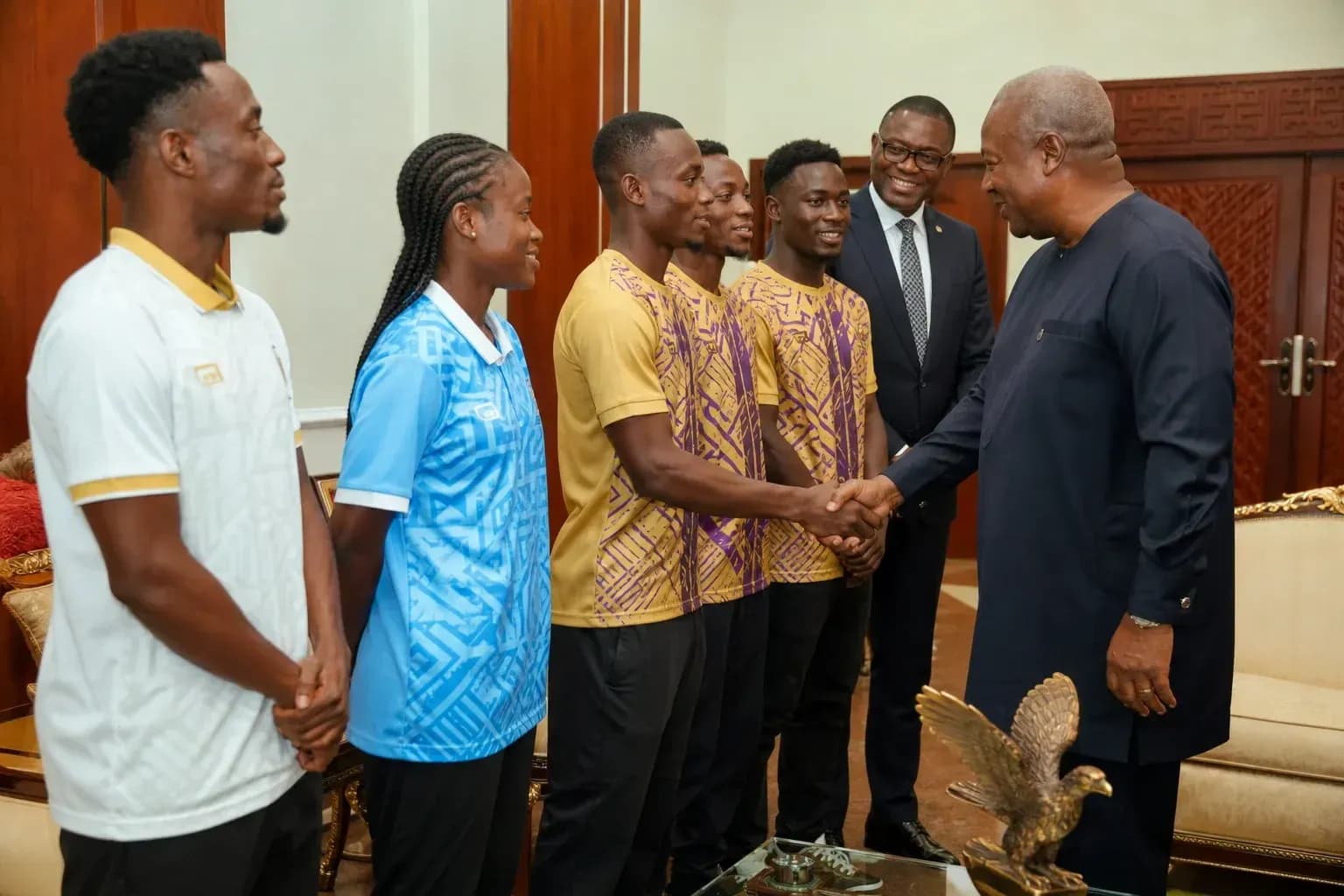 Athletes meeting with a government official indoors Athletes meeting with a government official indoors