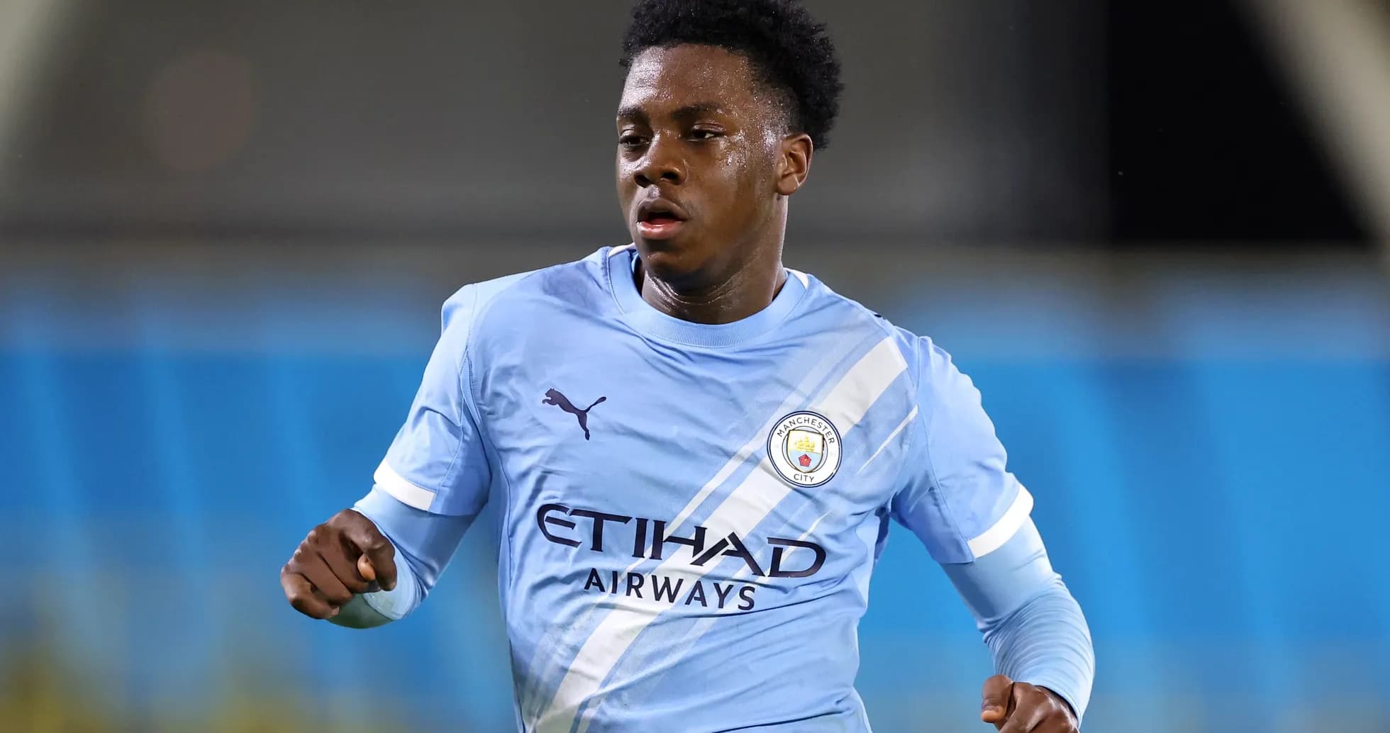 Player running in Manchester City home kit Player running in Manchester City home kit