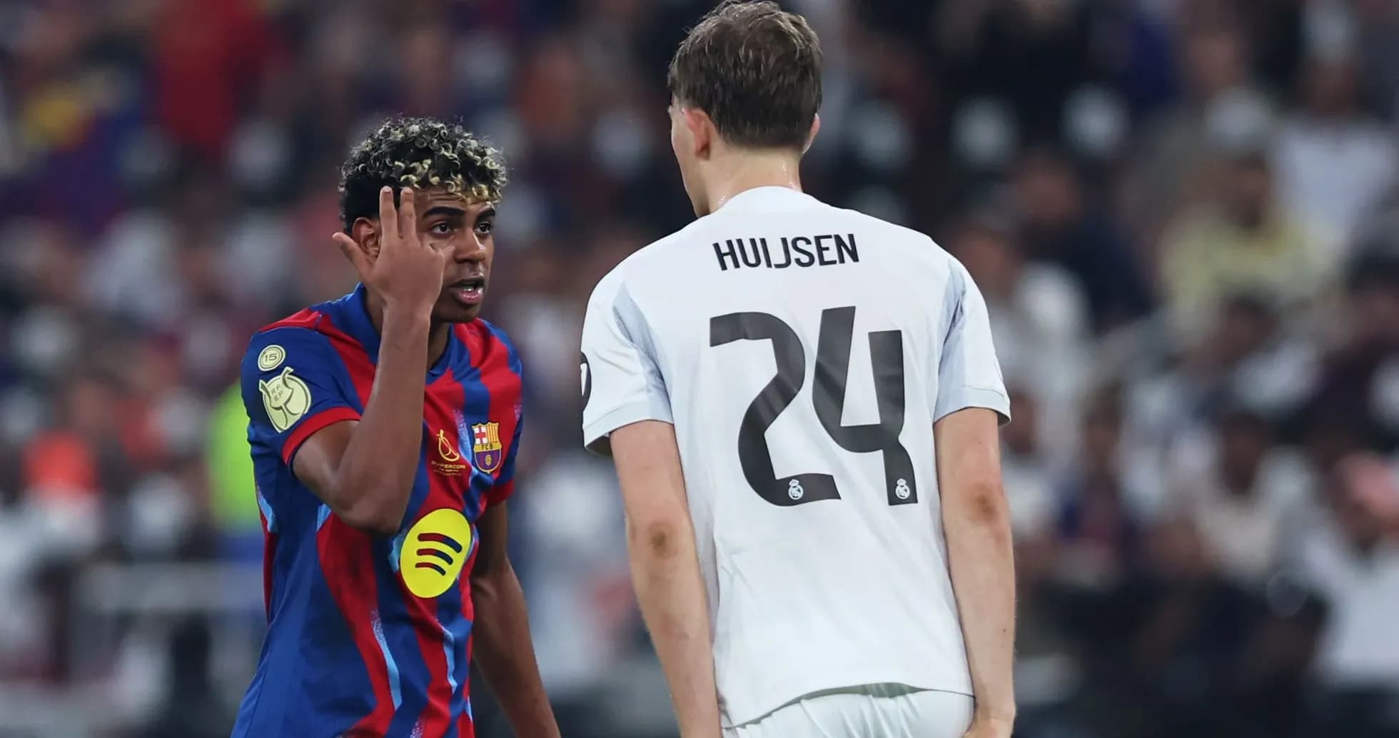 Barcelona player gesturing towards Real Madrid opponent Barcelona player gesturing towards Real Madrid opponent