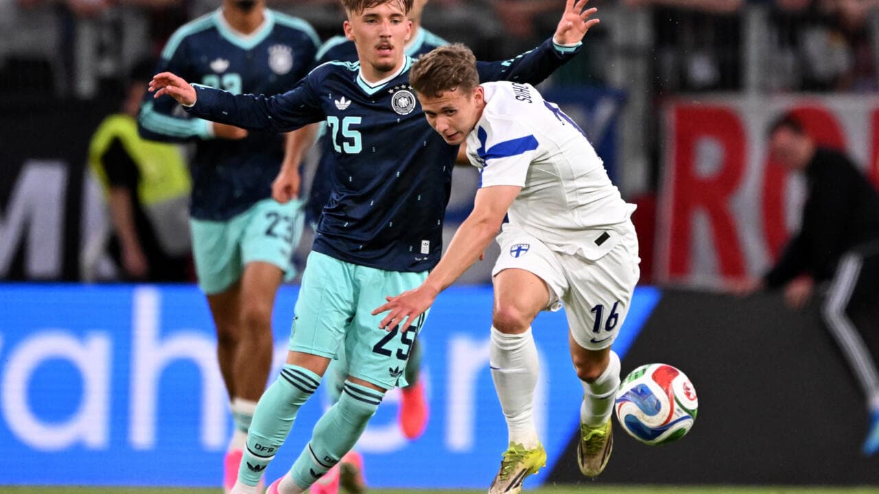 Players battling for possession during a football match Players battling for possession during a football match