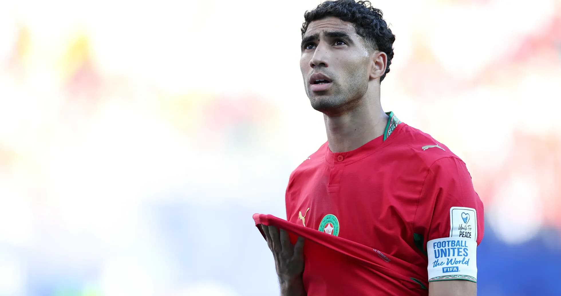 Player in red jersey looking upwards during match Player in red jersey looking upwards during match