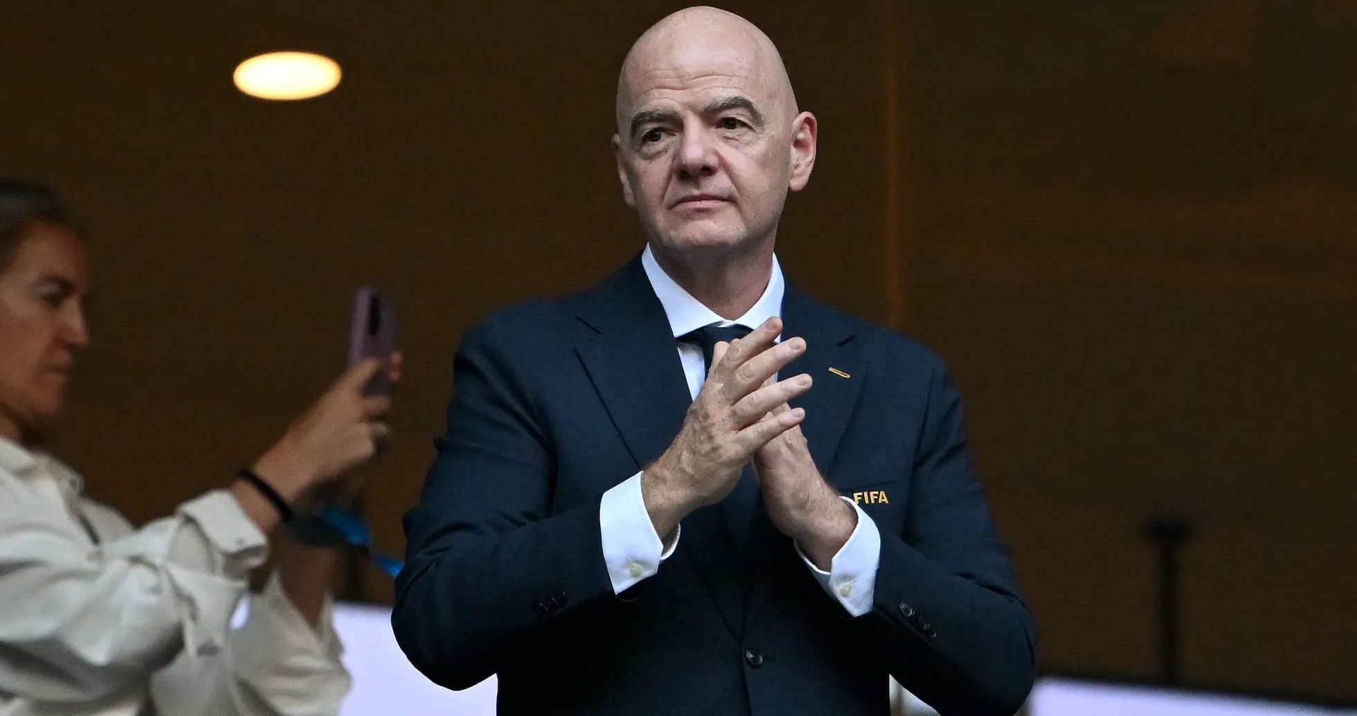 FIFA official applauding in a stadium box FIFA official applauding in a stadium box