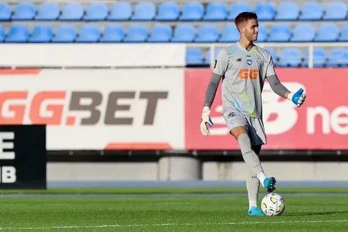 Goalkeeper in training with ball at feet Goalkeeper in training with ball at feet