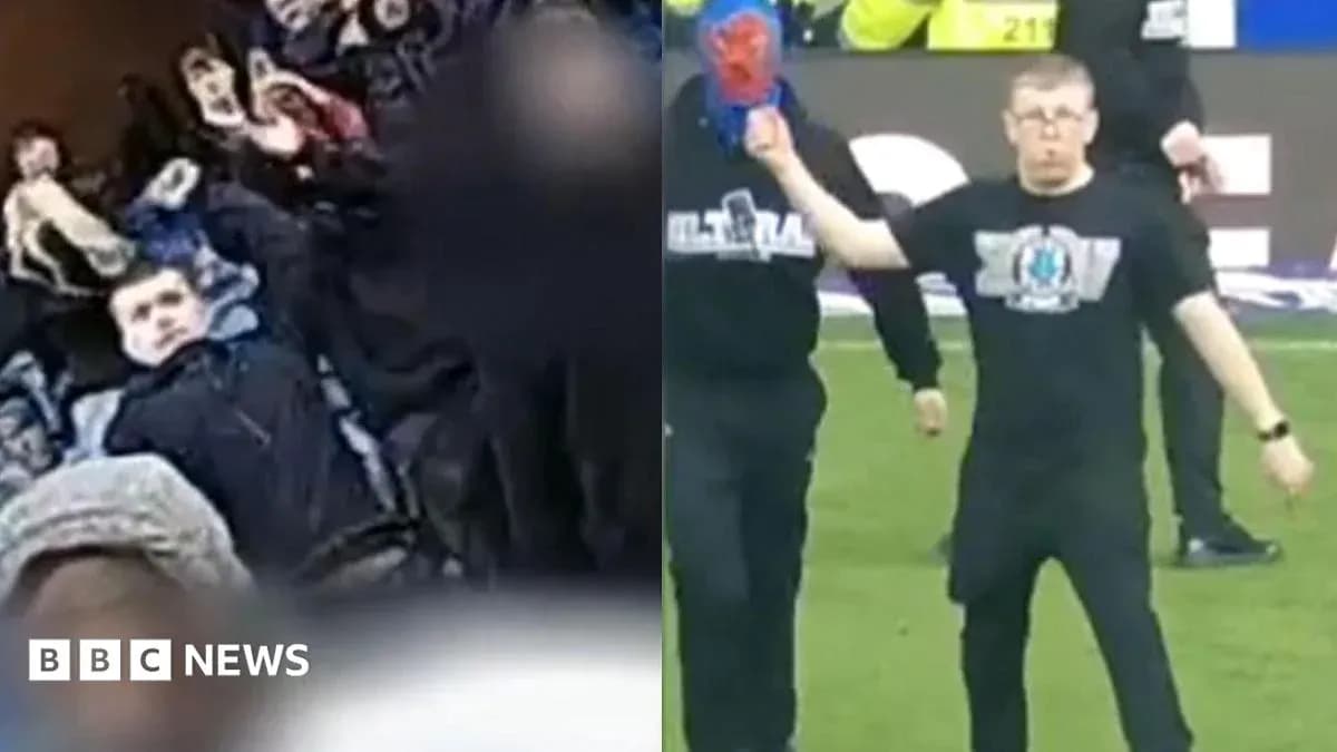 Fans in stands and a person on the pitch Fans in stands and a person on the pitch